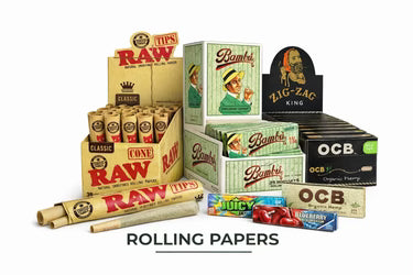 Display of various branded rolling papers and tips, including RAW classic cones and tips, Bambu, Zig-Zag King, Juicy Jay flavored papers, and OCB organic hemp papers.