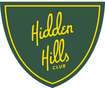 Green shield-shaped emblem with a thin yellow border and the words "Hidden Hills Club" in yellow cursive lettering centered inside